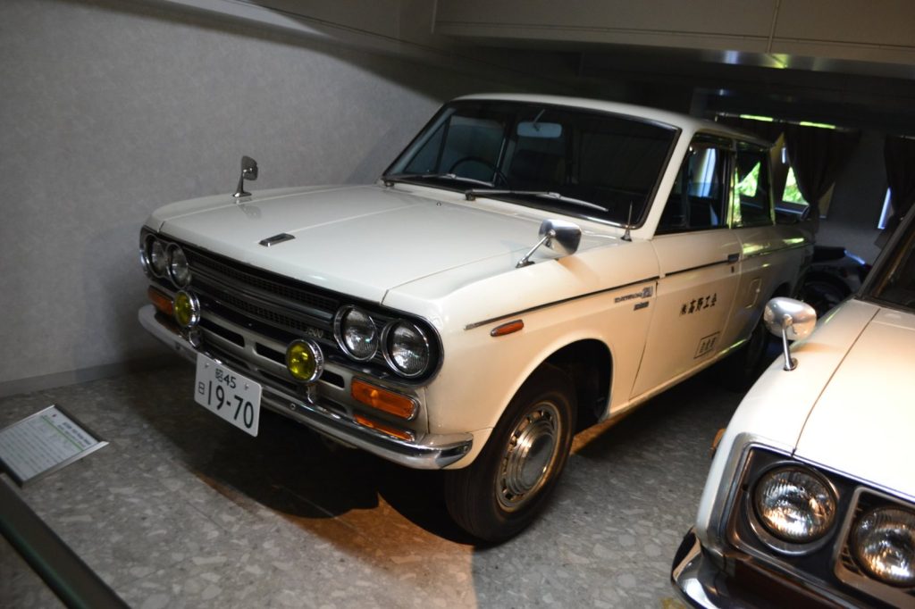 White Datsun 521 Truck 1500 displayed indoors.