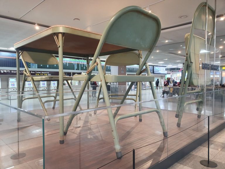 A Table, a Caption, and a Cheap Folding Chair