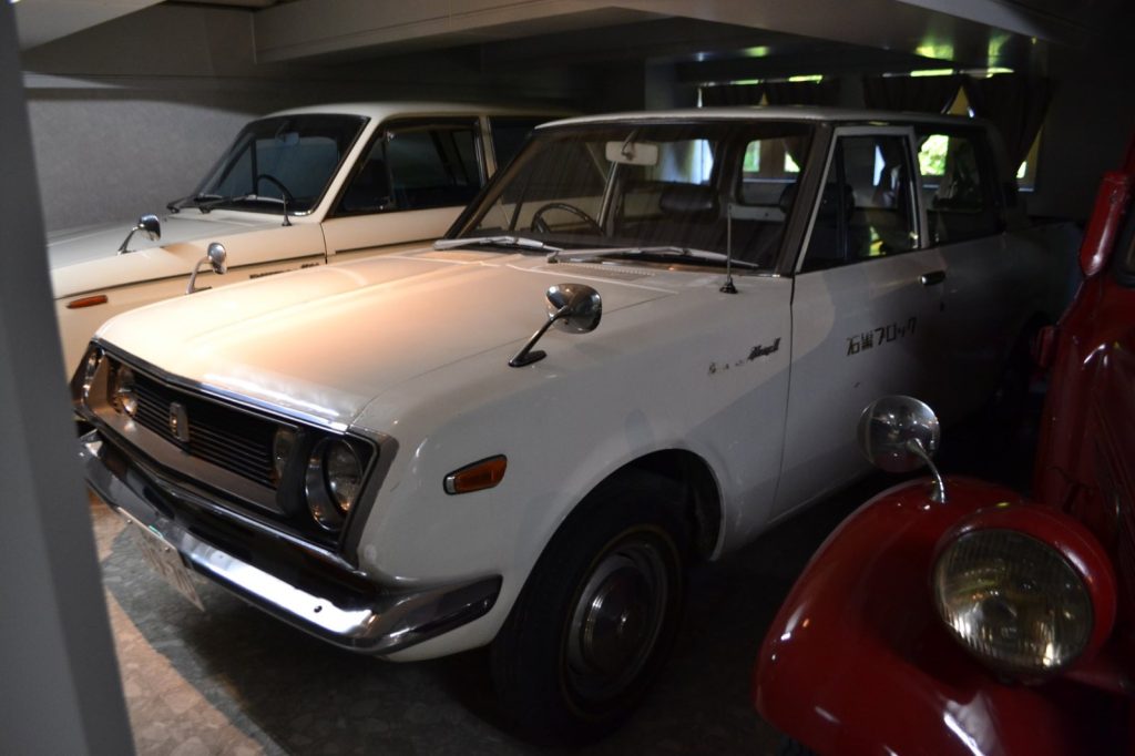 White Toyota Corona Mark II double pickup displayed indoors.